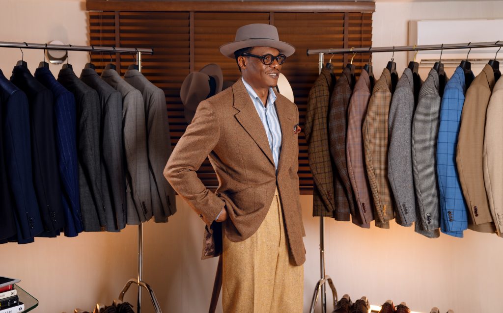 An open wardrobe of bespoke tailored cloths. Suits and jackets.